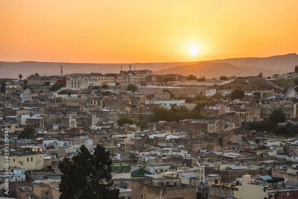 Panoramic scenic view over the roof tops of Medina Fes city at sunrise in Morocco