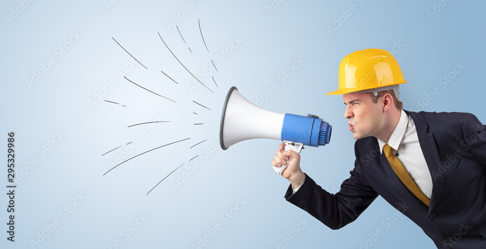 Young architect constructor yelling with megaphone and copyspace Young architect constructor yelling with megaphone and copyspace