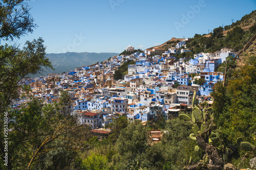 Scenic panoramic view of Chefchaouen from a hill on a sunny day, known as the blue city, Morocco