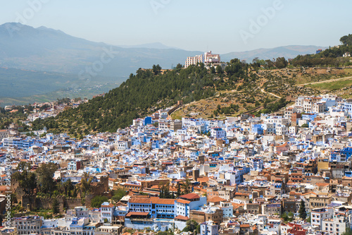 Scenic panoramic view of Chefchaouen from a hill on a sunny day, known as the blue city, Morocco © icephotography