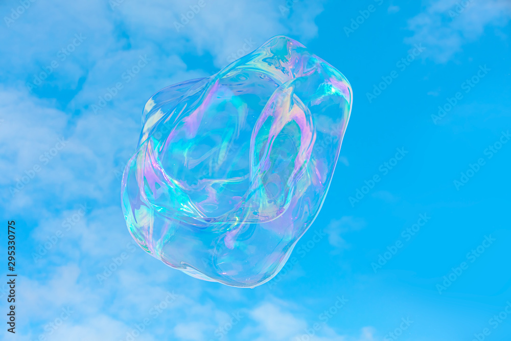 Blowing big soap bubbles in the air against blue cloudy sky Blowing big soap bubbles in the air against blue cloudy sky