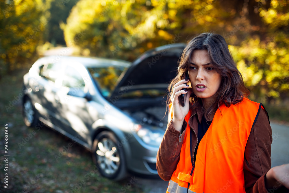 Woman calling for car assistance on the road Woman calling for car assistance on the road