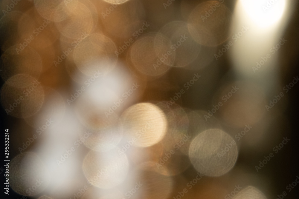 Blurred nature background with sun flare of tree looking upward in blue Blurred nature background with sun flare of tree looking upward in blue