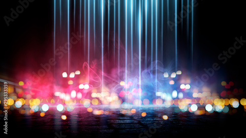 Dark street of the night city. Abstract bokeh light. Reflection on the wet asphalt, the lights of the night city. Dark background with abstract bokeh, rays of light. photo