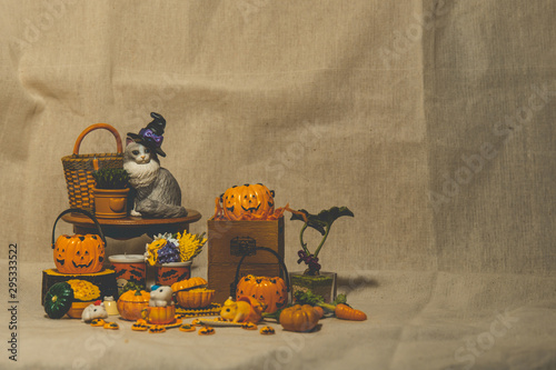 halloween holiday decoration concept, A lot of halloween party object miniature toys decoration on wrinkled calico background.