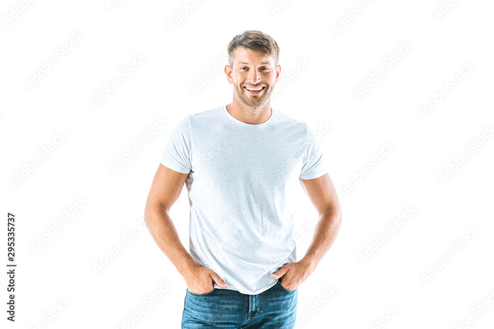 cheerful and handsome man standing with hands in pockets isolated on white cheerful and handsome man standing with hands in pockets isolated on white