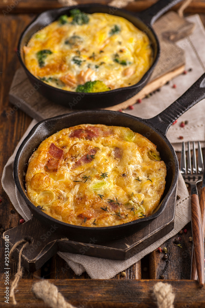 Home cooked frittata on a wooden table. Home cooked frittata on a wooden table.