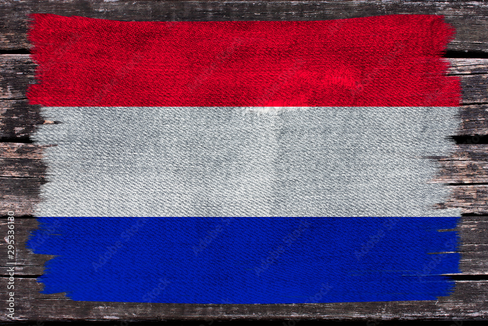 photo of the beautiful colored national flag of the modern state of the Netherlands on textural fabric, concept of tourism, economics and politics, closeup