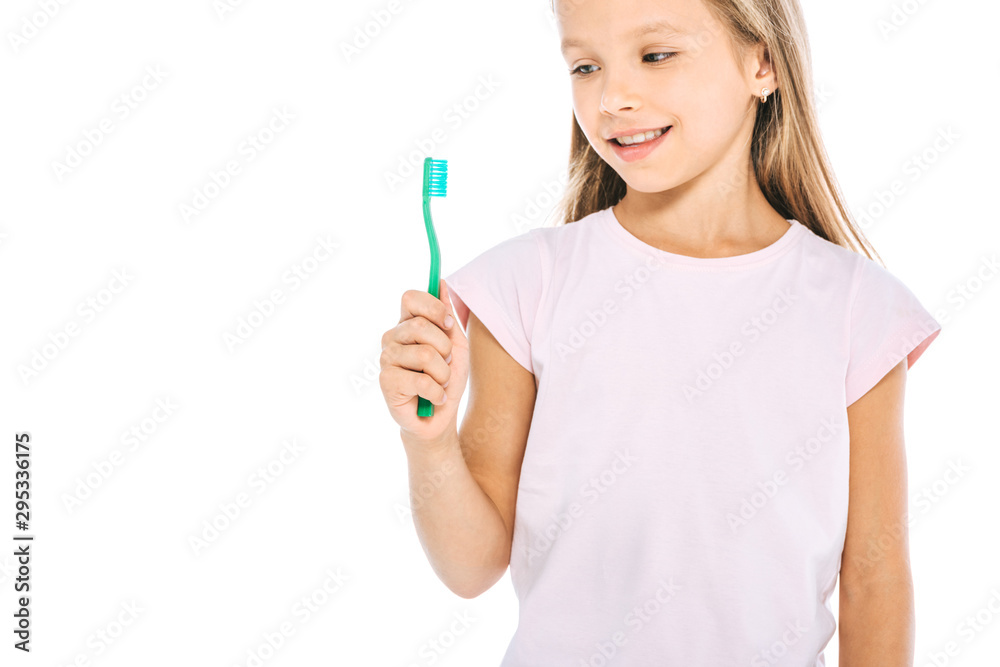 happy kid looking at toothbrush and smiling isolated on white happy kid looking at toothbrush and smiling isolated on white