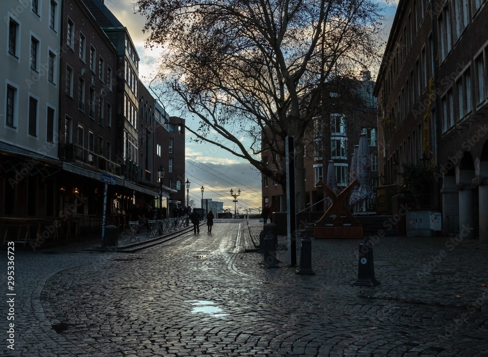 background of evening city street with people silhouettes, Dusseldorf, Germany December 10, 2018