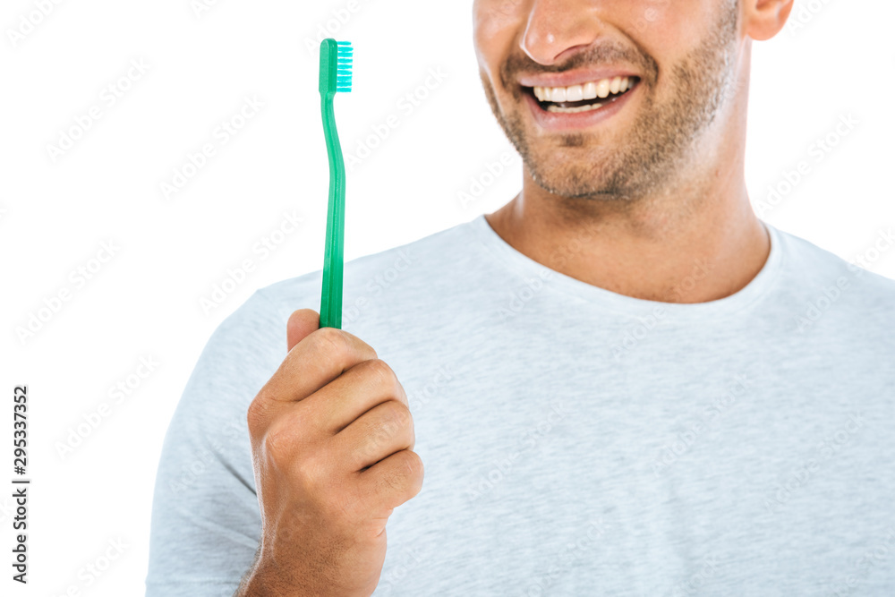 cropped view of man holding toothbrush and smiling isolated on white