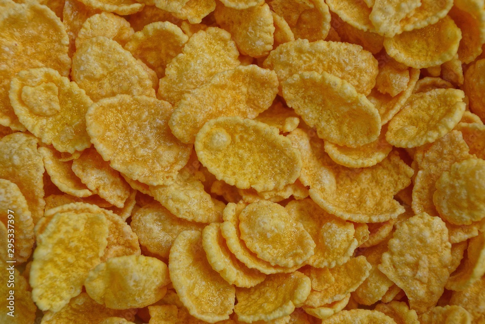 yellow natural texture of a pile of small dried corn flakes yellow natural texture of a pile of small dried corn flakes