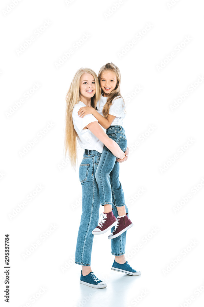 happy mother holding in arms cute daughter and standing on white happy mother holding in arms cute daughter and standing on white