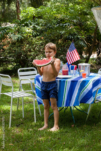 Kids Eating watermelon in their yard on the fourth of July