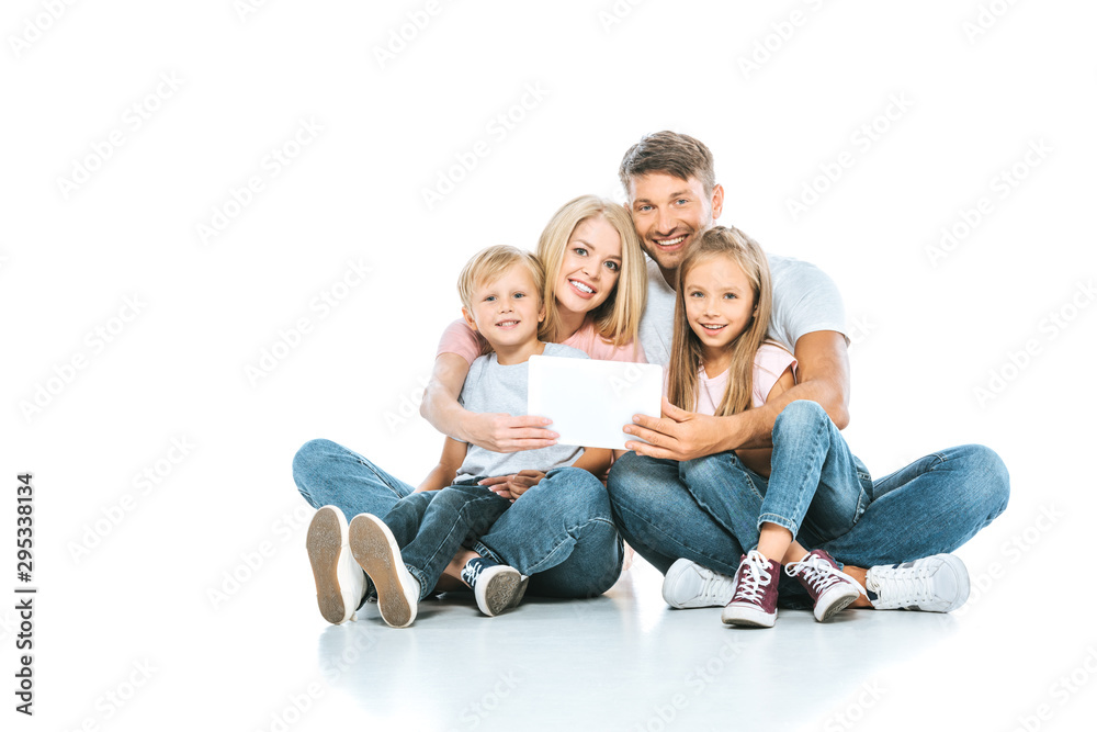 happy parents and kids holding card while sitting on white