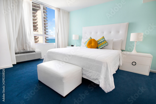 Sea view bedroom of luxury summer beach house with queen bed with colorful interior design