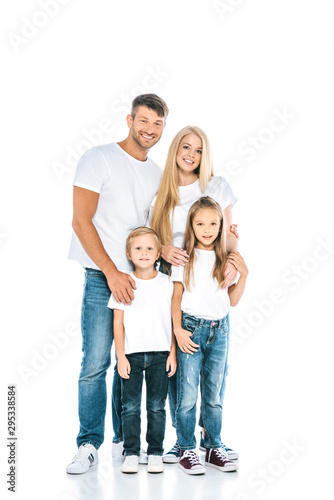 adorable children standing with happy parents and looking at camera on white