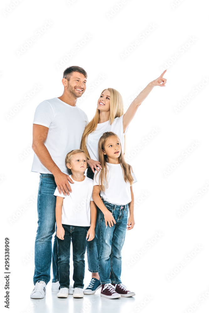 happy woman looking at husband while pointing with finger near kids on white happy woman looking at husband while pointing with finger near kids on white