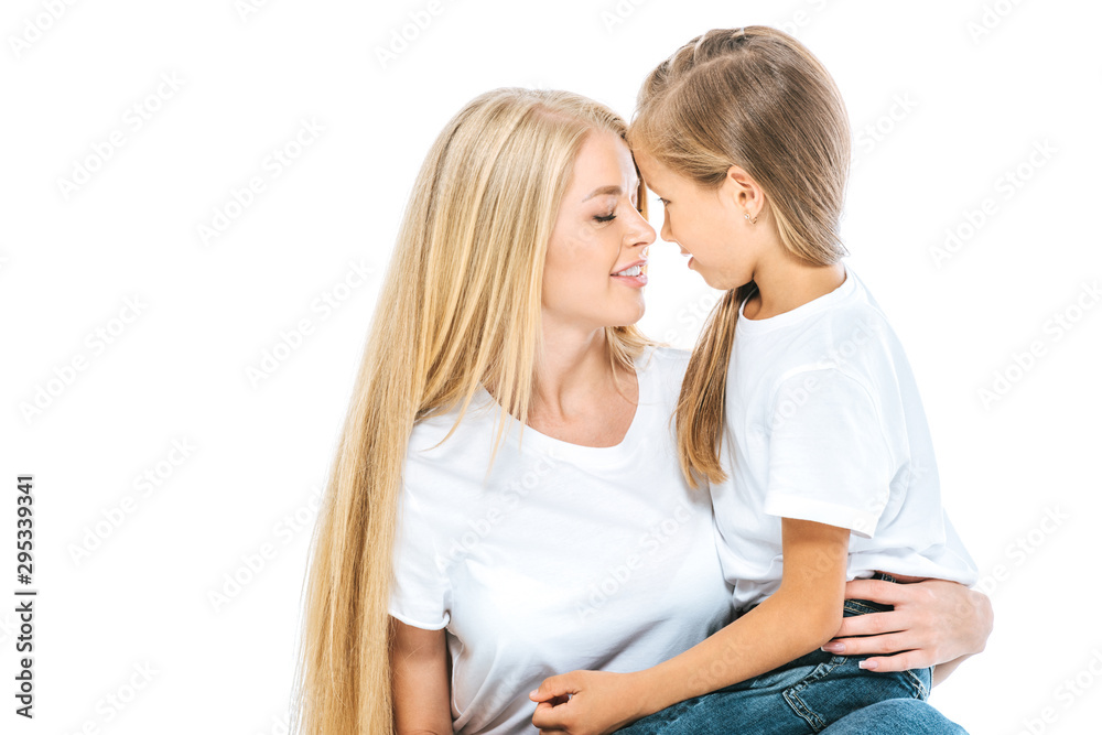 beautiful mother and cute daughter looking at each other isolated on white beautiful mother and cute daughter looking at each other isolated on white