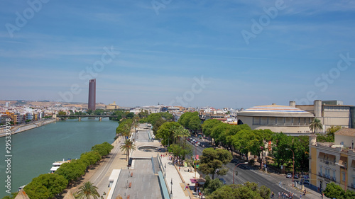 Panoramic views of the city from the military watchtower Torre del Oro towards The Guadalquivir river, Triana bridge, the promenade and Cajasol Tower on the west bank, Seville, Spain