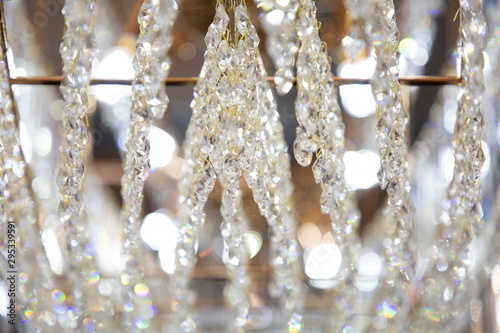 luxury hanging crystal chandelier shiny decoration interior , blur bokeh light lamp at background . beautiful electricity expensive furniture . © Rattanachai