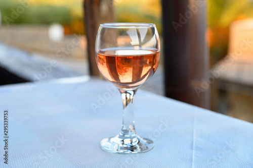 a glass of rose wine on the table in the restaurant