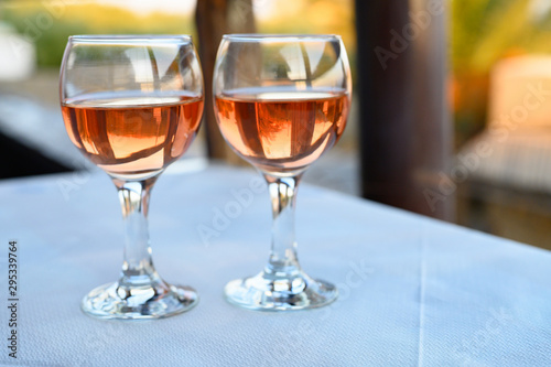 a glass of rose wine on the table in the restaurant