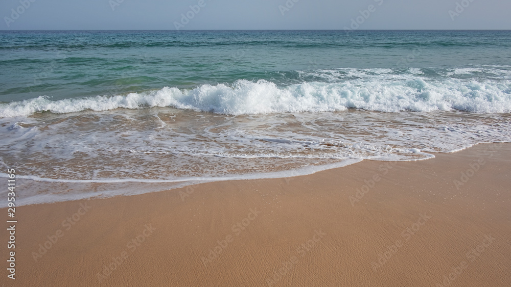 Frothy waves washing the pristine beach Playa Jandia, in Fuerteventura, one of the most attractive tourist destinations in the Canary Islands, for its white sandy beaches, mild climate and wild nature
