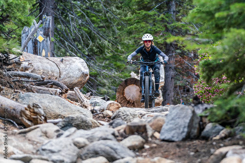 female mountain biker on rock garden