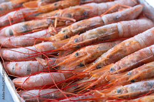 Large frozen langoustines in a package. Seafood. photo