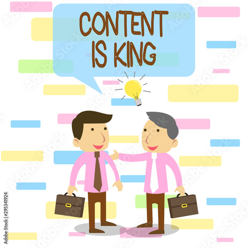 Writing note showing Content Is King. Business concept for believe that content is central to the success of a website Two White Businessmen Colleagues with Brief Cases Sharing Idea Solution