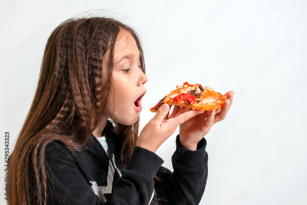 Little brunette girl eating pizza