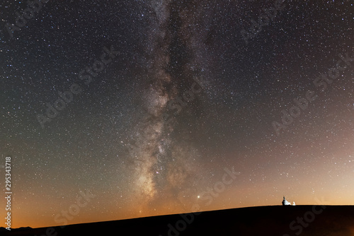 Beautiful milky way galaxy Over the hill and small church silhouette.