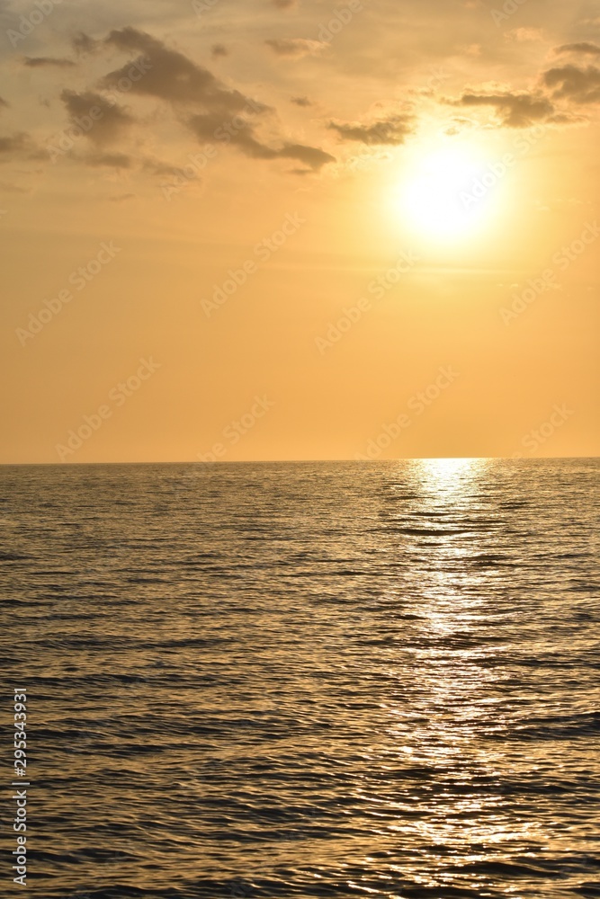 Background of an Orange and yellow sunset over the sea