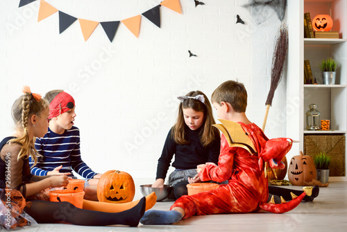Cheerful Cute children in costumes ready for trick-or-treating Halloween holiday concept