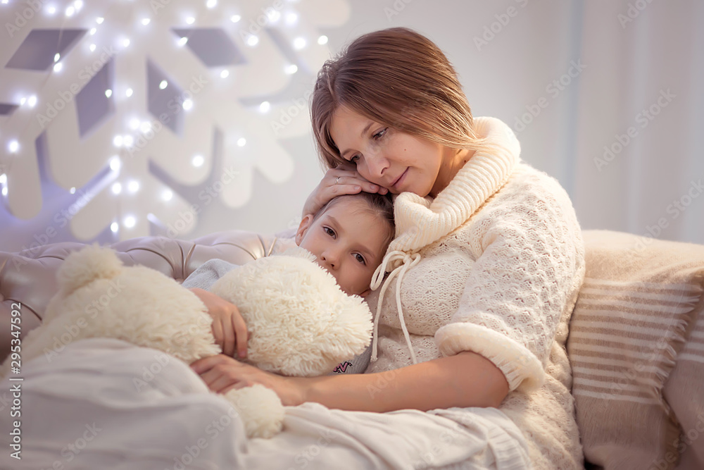 The girl got sick. Mom hugs and kisses a sick daughter The girl got sick. Mom hugs and kisses a sick daughter
