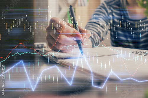 Financial forex graph drawn over hands taking notes background. Concept of research. Double exposure © peshkova