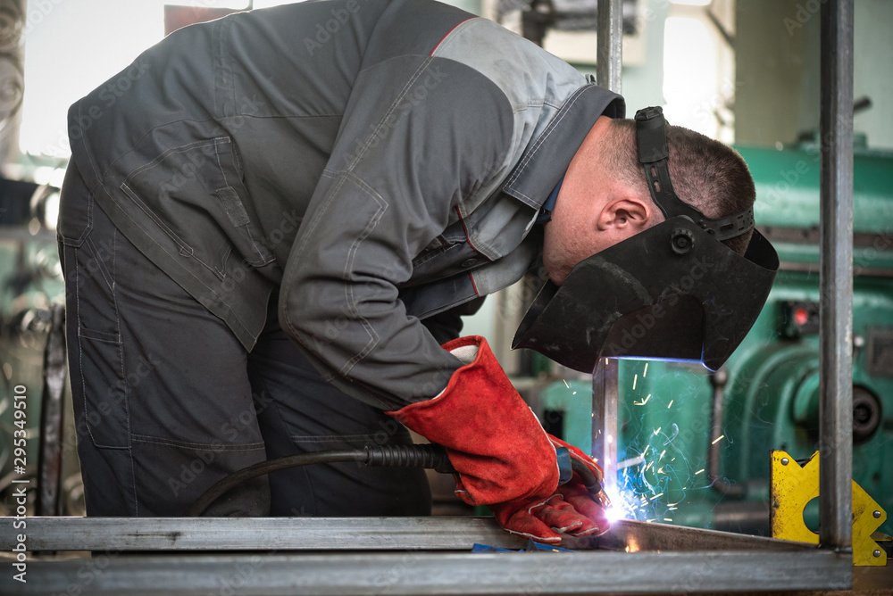 Fototapeta premium Welder is welding a metal frame.