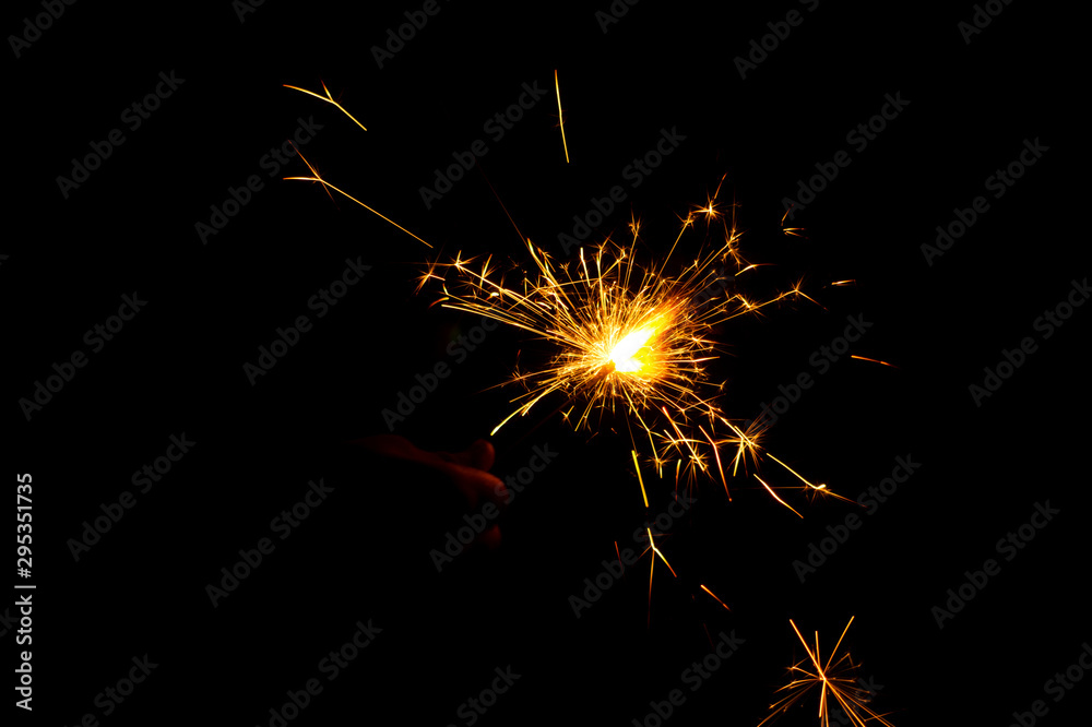 Colorful fireworks in night, bright sparkler candle for Christmas or new year Festival celebration isolated on black background, Blazing colored fire, Diwali Firework crackers sparkle lights on hand