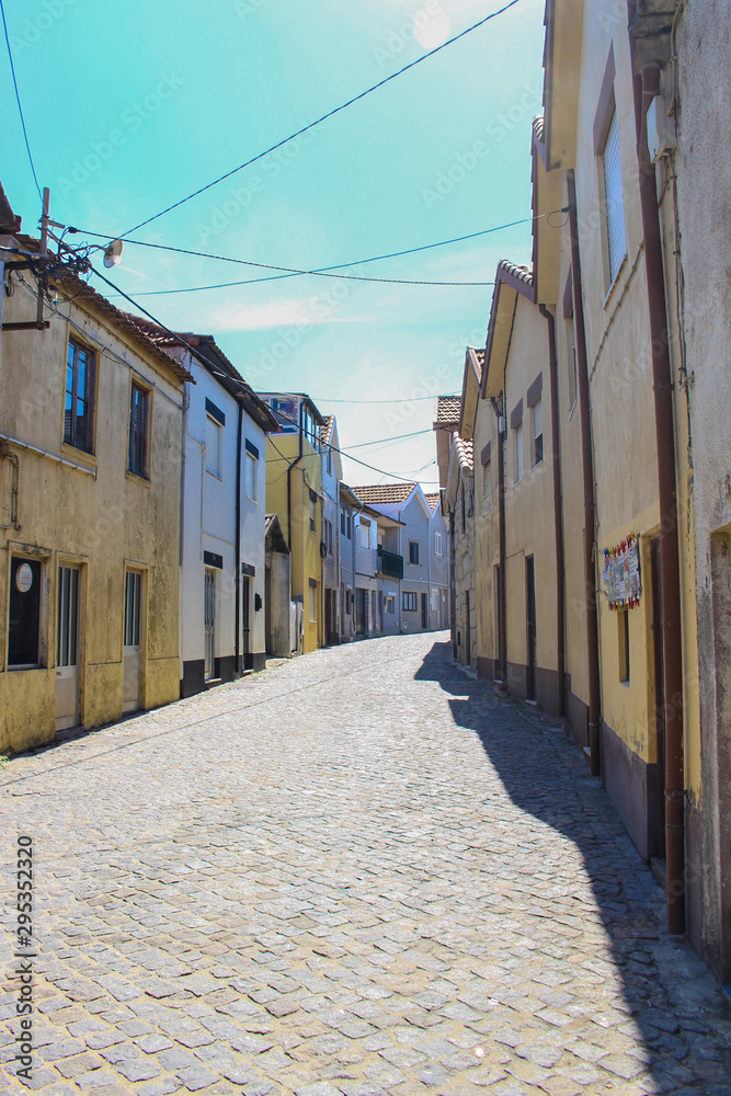 View on the beautiful old small buildings with portuguese tiles on the facades in the town of Vila Cha, Portugal