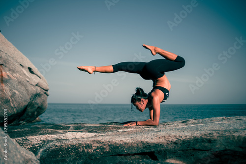 Asian woman yoga on the beach