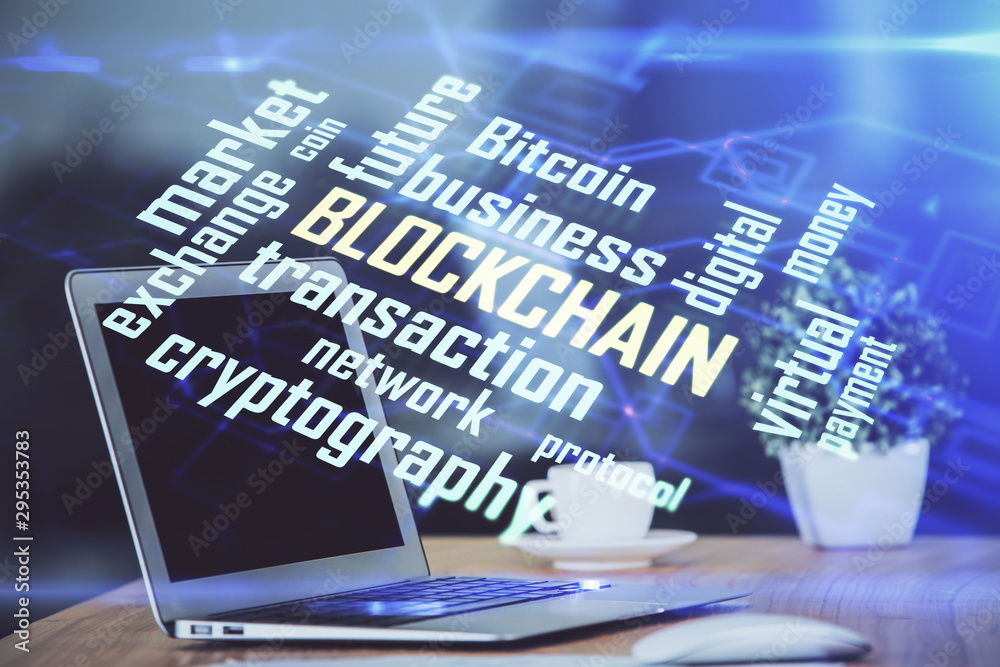 Multi exposure of blockchain theme hologram and table with computer background. Concept of bitcoin crypto currency.