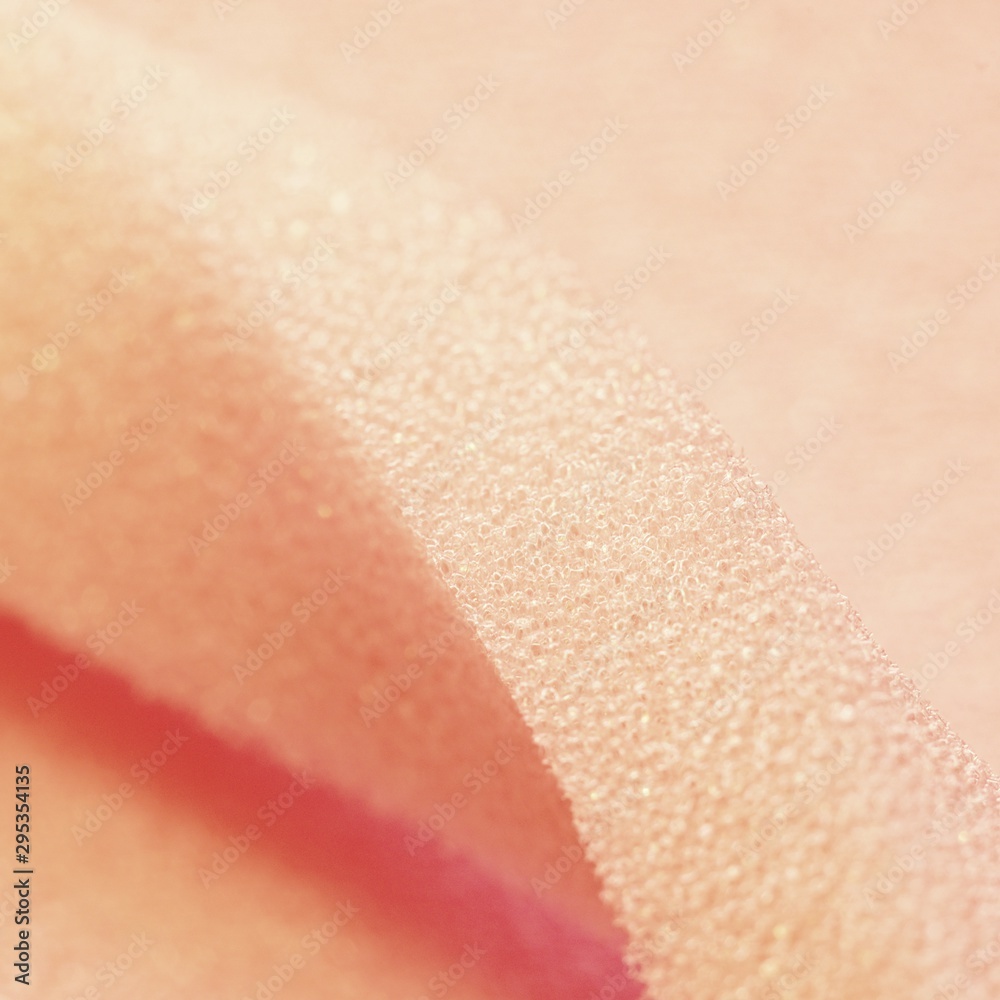 Fototapeta premium White pink artificial foam, soft texture on a light background.