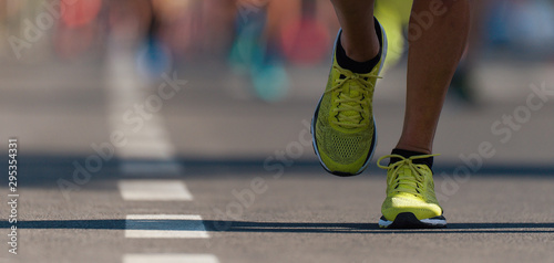 Marathon running race, people feet on city road