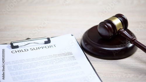 Child support document table, gavel lying on sound block, family law, court