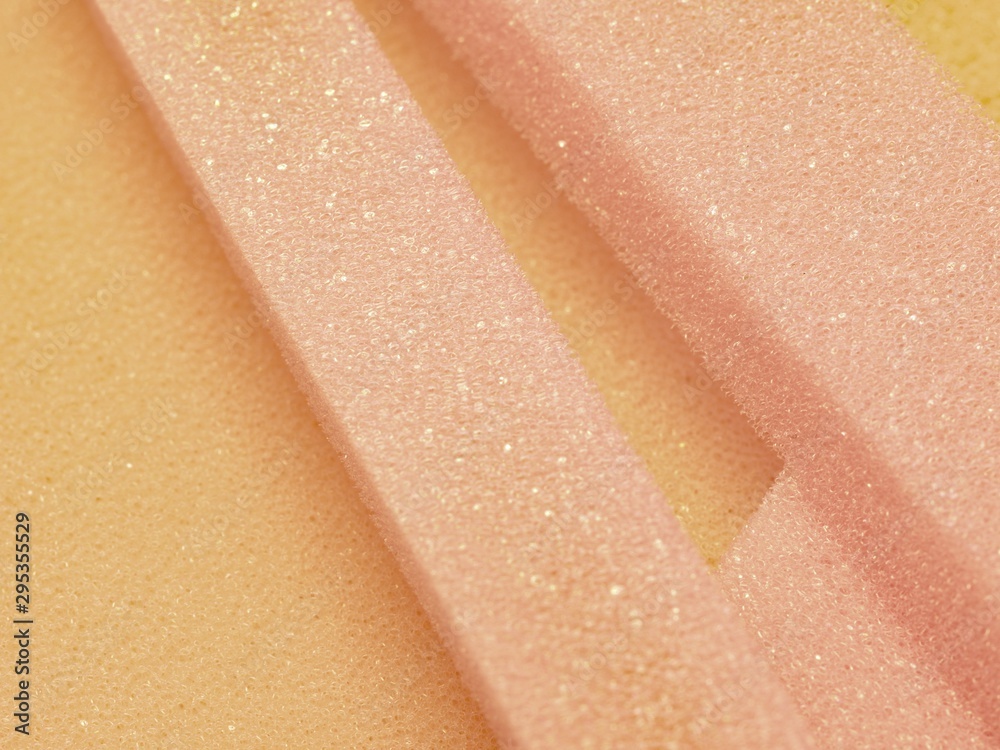 Fototapeta premium White pink artificial foam, soft texture on a light background.