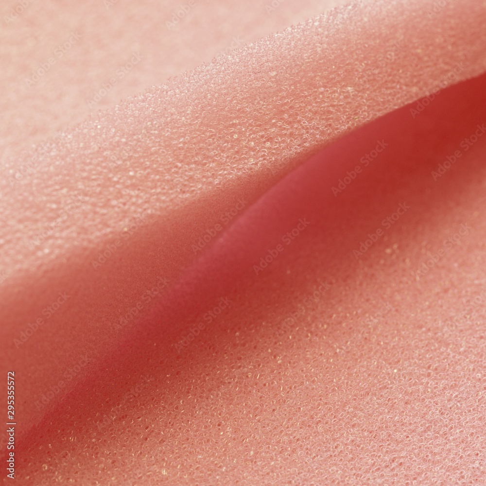 White pink artificial foam, soft texture on a light background. White pink artificial foam, soft texture on a light background.