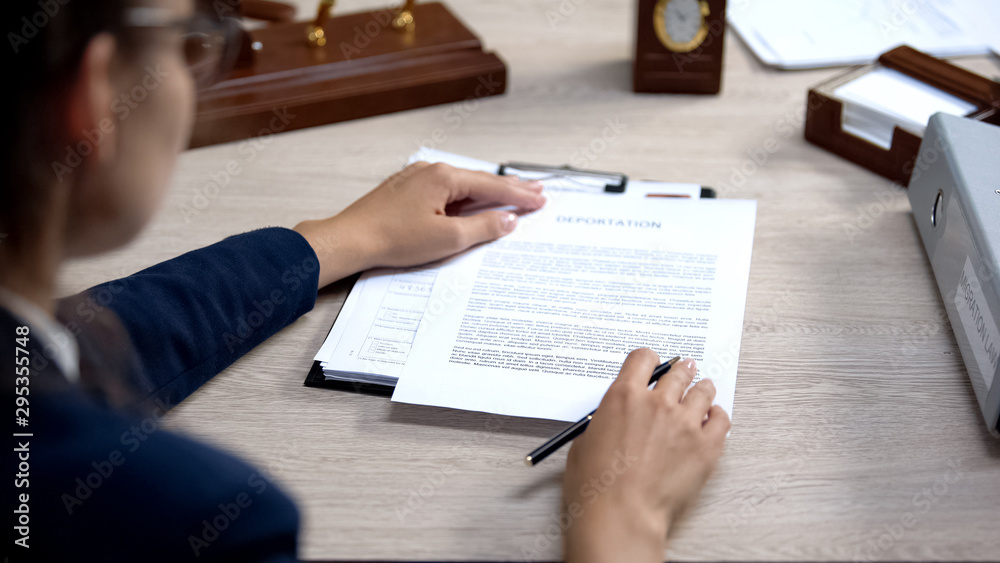 Employee looking through visa application, deportation document checking Employee looking through visa application, deportation document checking
