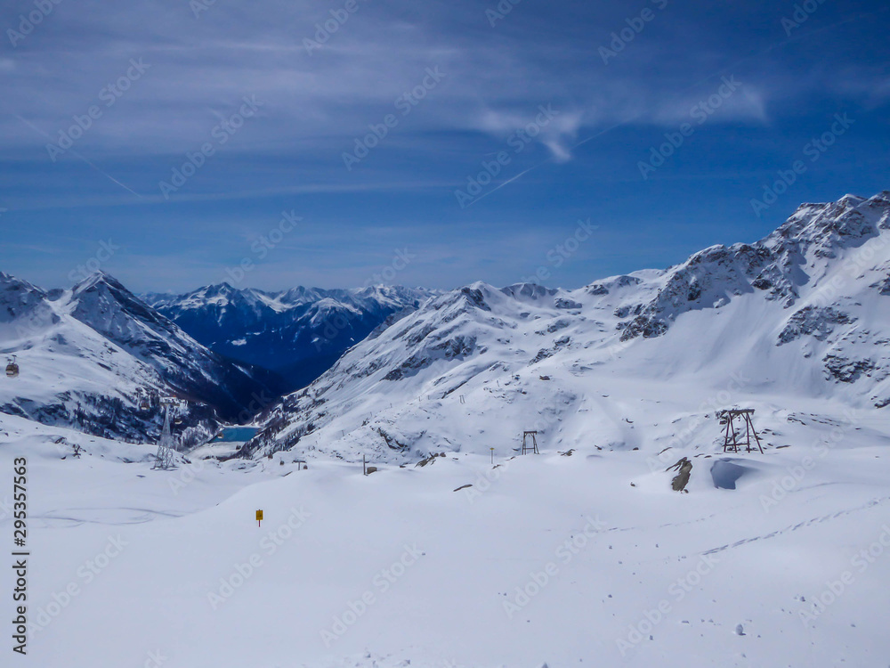 Beautiful and serene landscape of mountains covered with snow in Mölltaler Gletscher, Austria. Thick snow covers the slopes. Clear weather. Perfectly groomed slopes. Massive ski resort. Glacier skiing Beautiful and serene landscape of mountains covered with snow in Mölltaler Gletscher, Austria. Thick snow covers the slopes. Clear weather. Perfectly groomed slopes. Massive ski resort. Glacier skiing