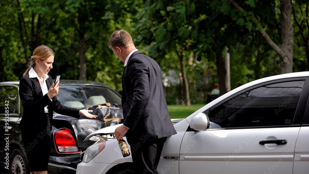 Stressed woman calling police standing car collision scene near drunk driver Stressed woman calling police standing car collision scene near drunk driver